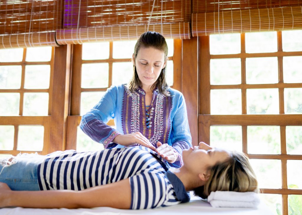 A Shamballa Reiki Master performing Reiki on a student. 