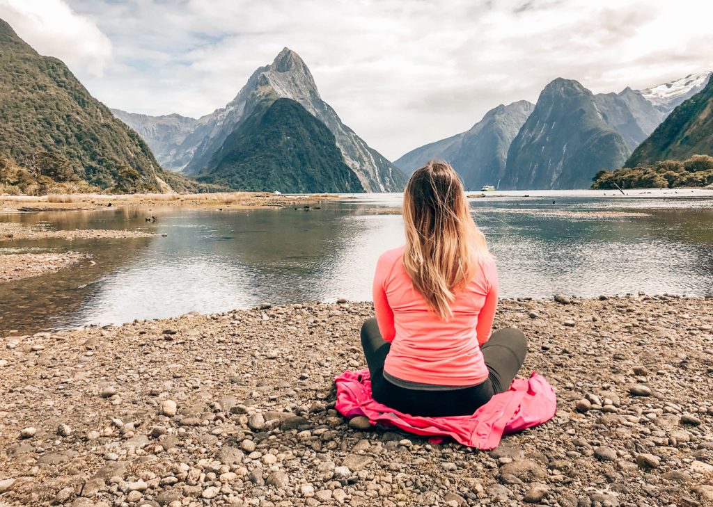 A woman sitting by the lake searching for answers.