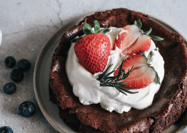 Flourless chocolate cake garnished with fresh berries